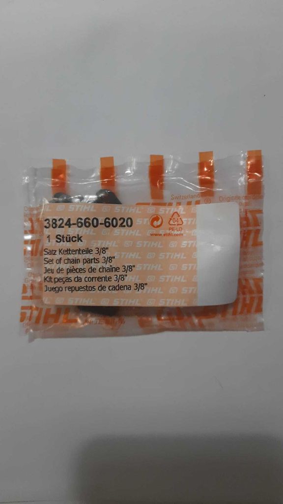 A sealed plastic package containing chainsaw parts.