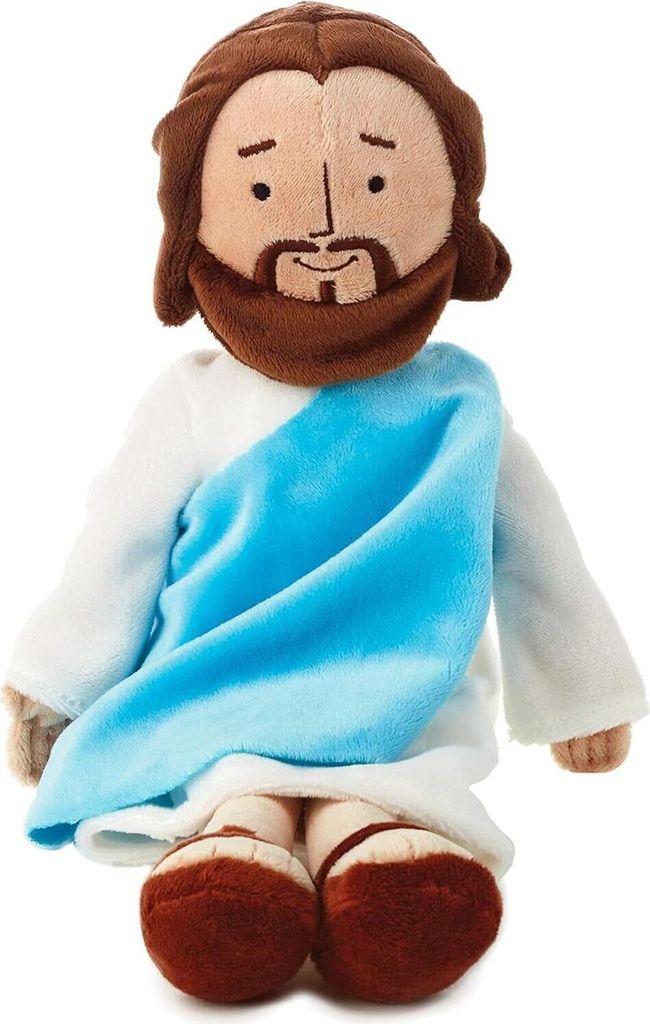 A plush doll of Jesus sitting down.