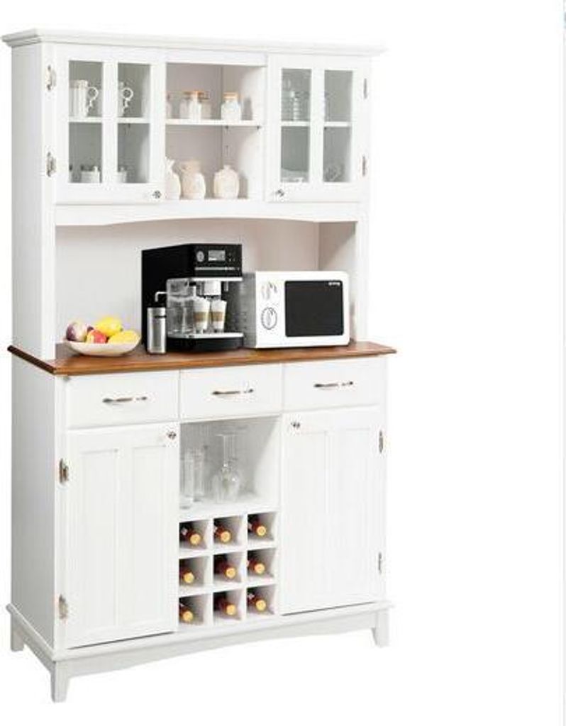 A white kitchen cabinet with a wooden countertop, a coffee maker, a microwave, and a fruit bowl.
