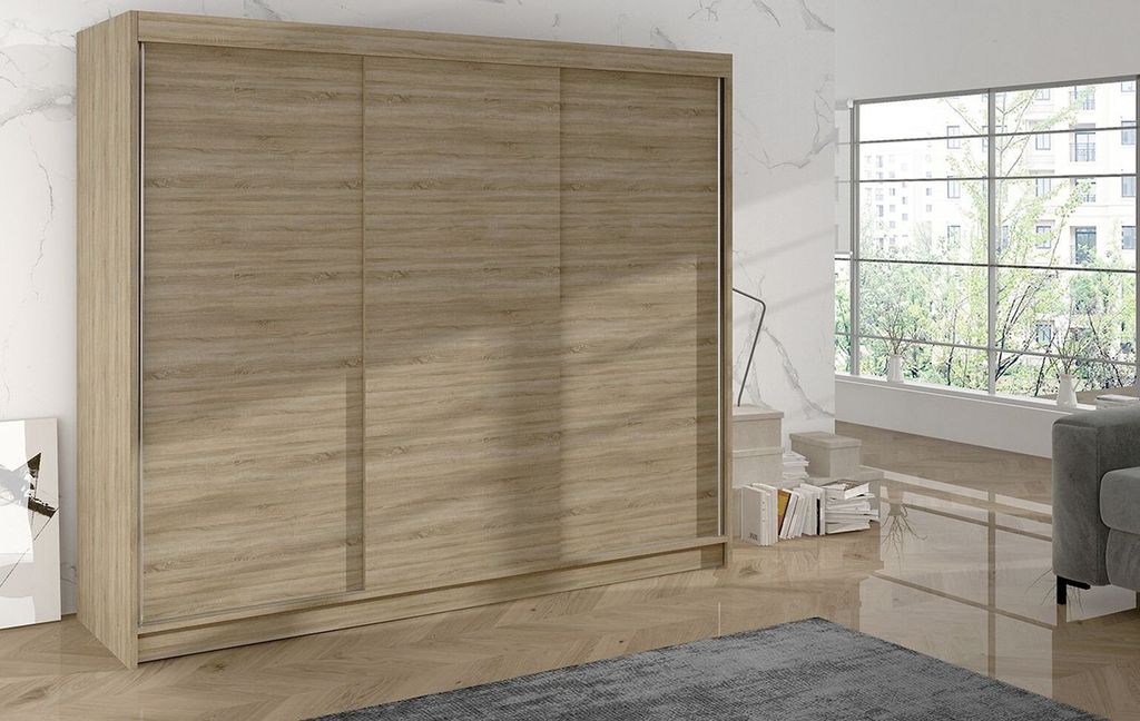 A large wooden wardrobe with sliding doors in a room with a large window.