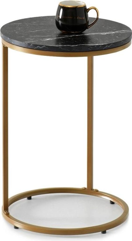 A small round side table with a black marble top and gold metal legs, with a black mug on top.