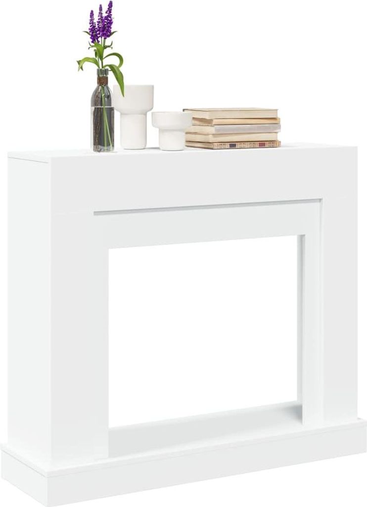 A white fireplace surround with decorative items on top.