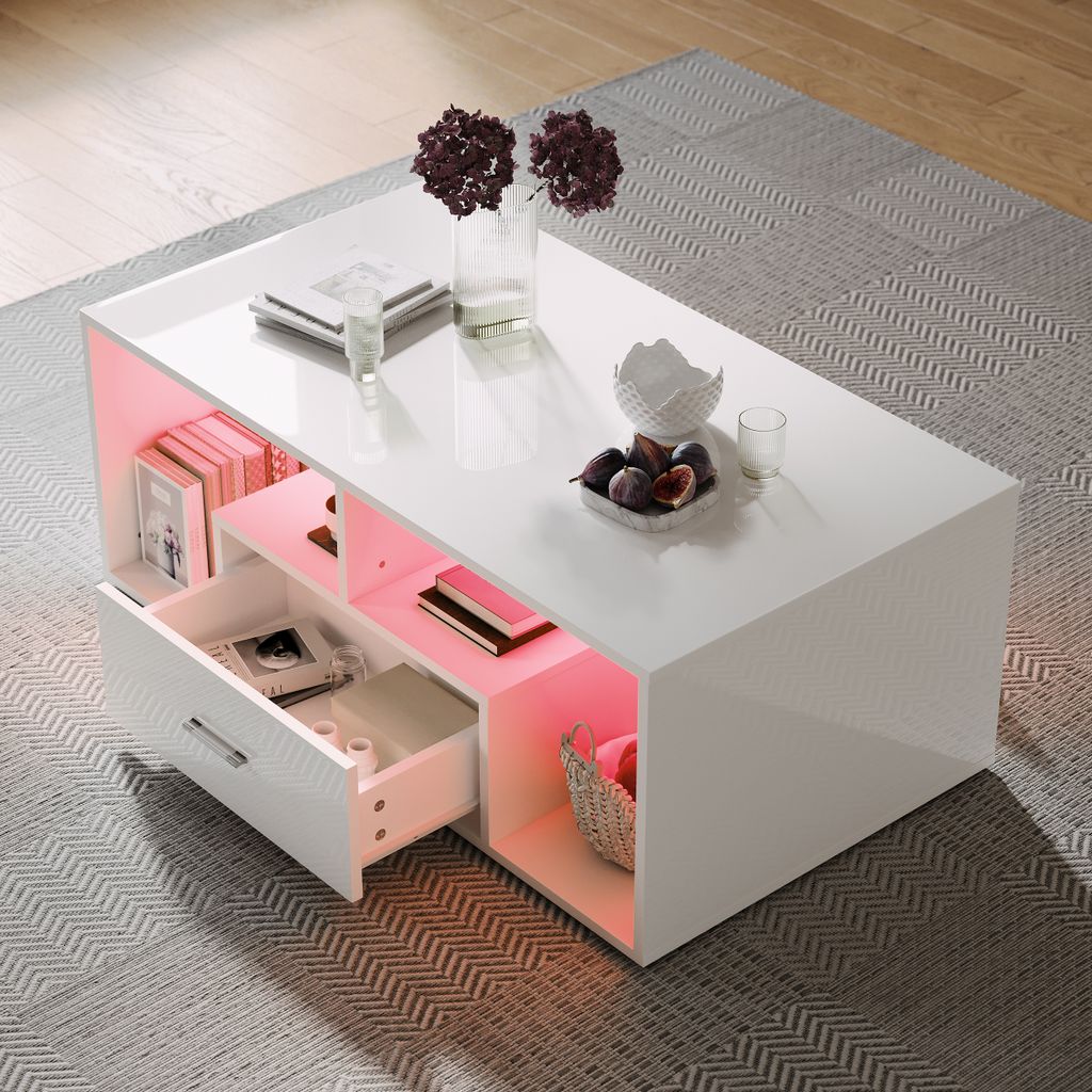 A modern white coffee table with integrated RGB LED lighting, placed on a patterned rug in a living room setting.