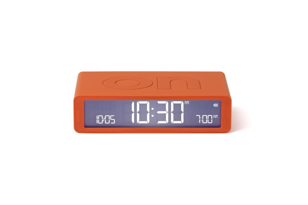 An orange digital alarm clock shown from the front on a white background.