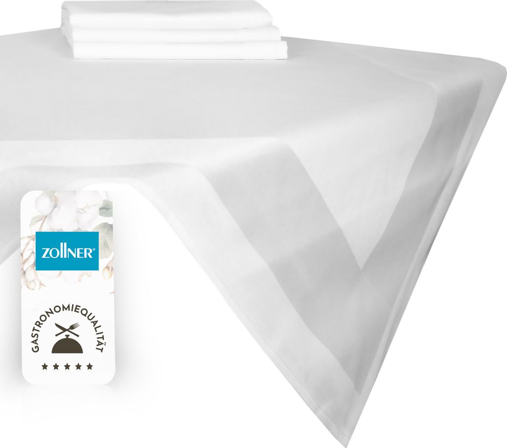 A white tablecloth with a folded stack of smaller white cloths on top, and a product label in the lower left corner.