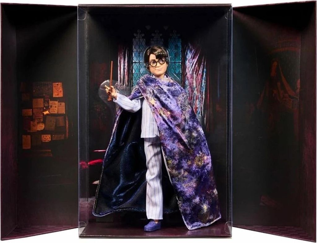 A Harry Potter doll in a display box, holding a wand.