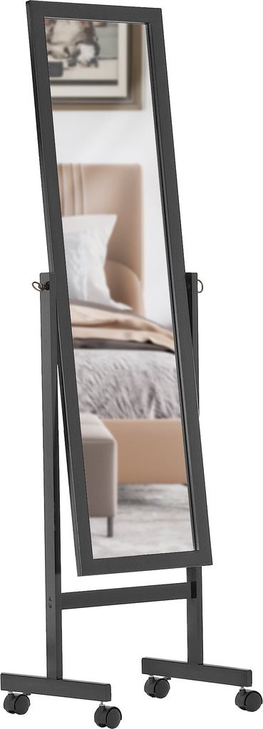 A full-length mirror on a stand with wheels, reflecting a bedroom scene.
