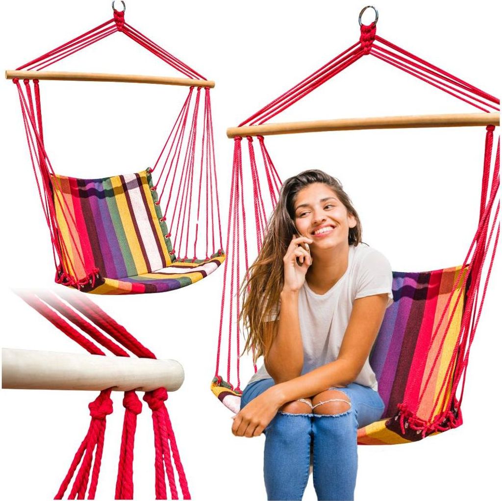 A woman is sitting in a colorful hammock chair and talking on her phone.