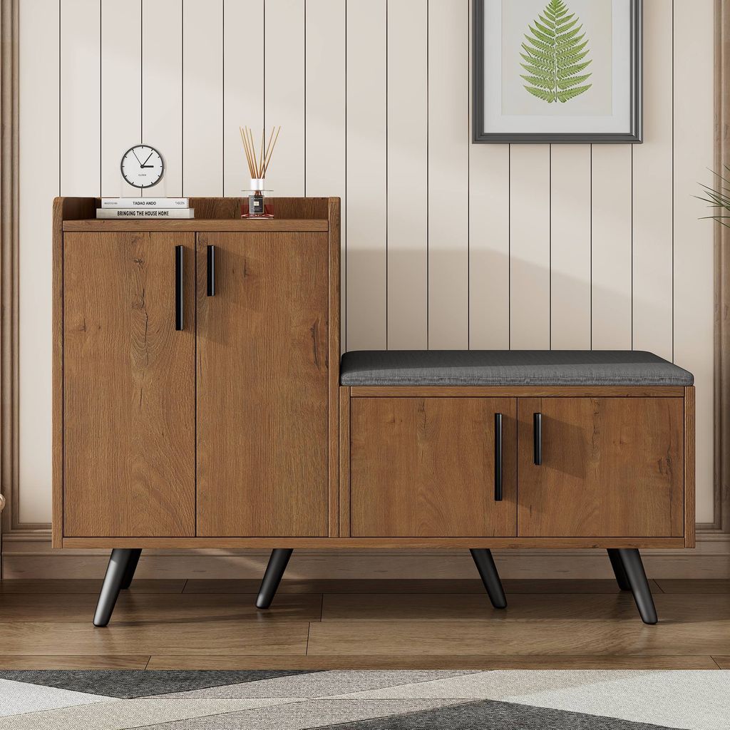 A shoe cabinet with a built-in bench is shown in a room with a wood-paneled wall.