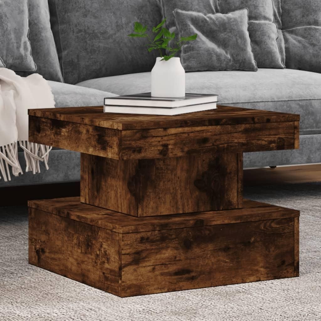 A wooden coffee table with books and a vase on top, placed in front of a sofa.