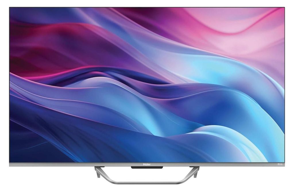 A front view of a Haier smart TV on a stand.