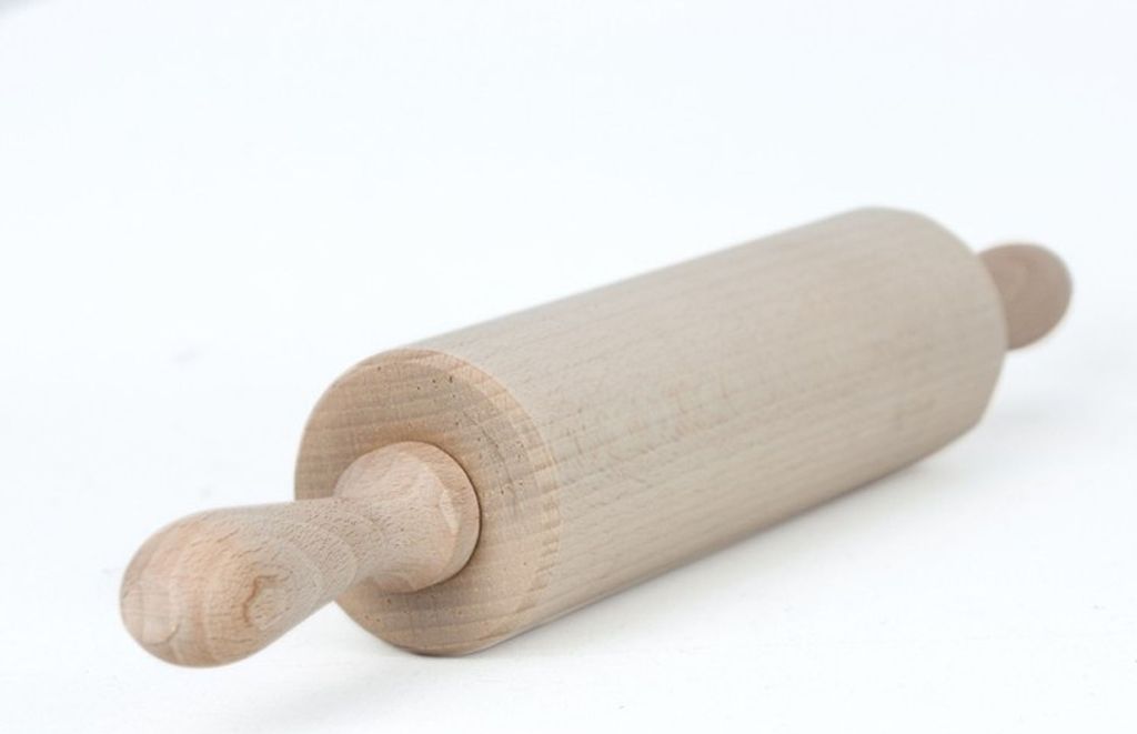 A wooden rolling pin on a white background.