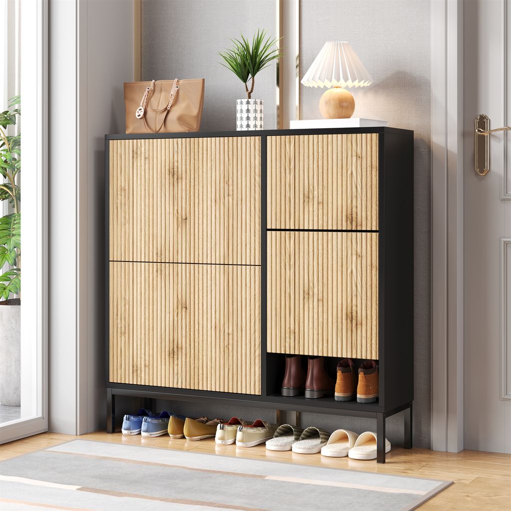 A shoe cabinet with a handbag and a lamp on top, placed in an entryway.
