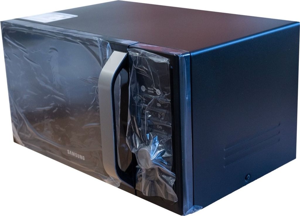 A black Samsung microwave oven is shown from a side angle, covered in protective plastic wrap.