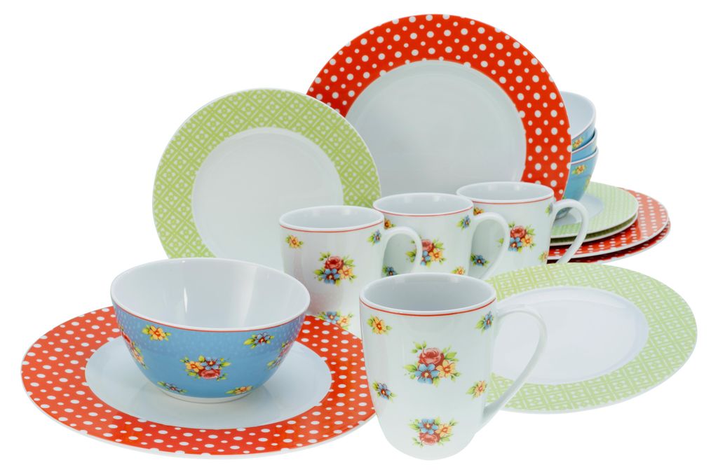 A collection of ceramic plates, bowls, and mugs with polka dot and floral patterns, arranged on a white background.