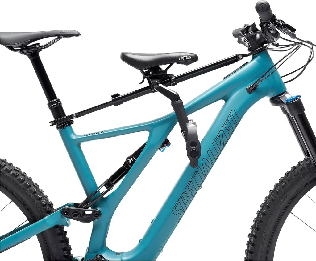 A teal mountain bike with a black child seat mounted on the frame.