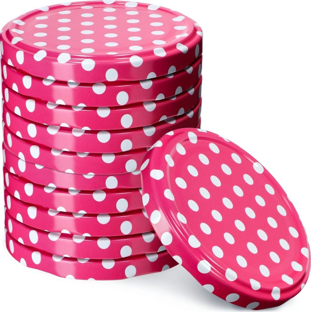 A stack of pink polka dot jar lids with one lid placed in front of the stack.