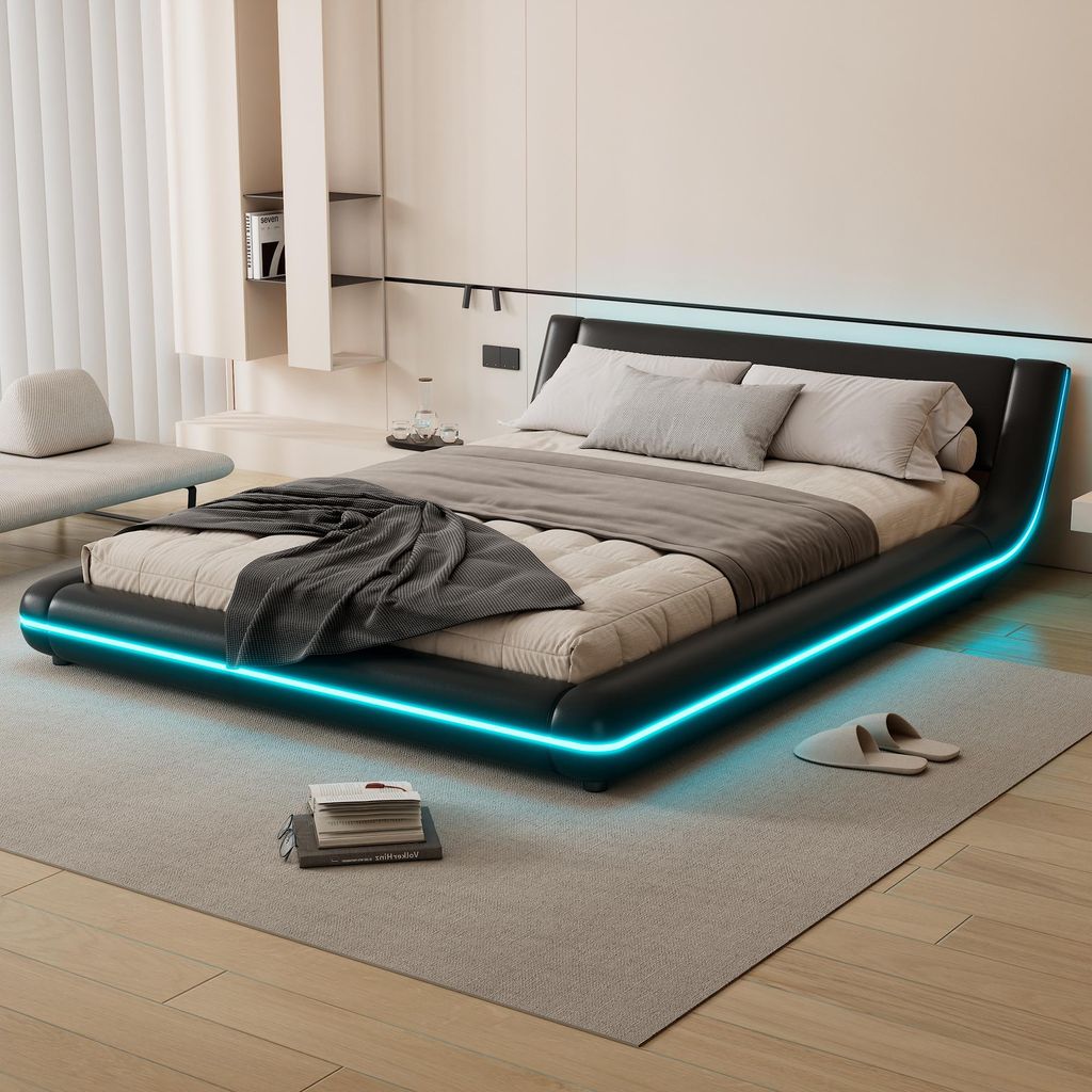 A modern bedroom with a black platform bed featuring blue LED lighting.