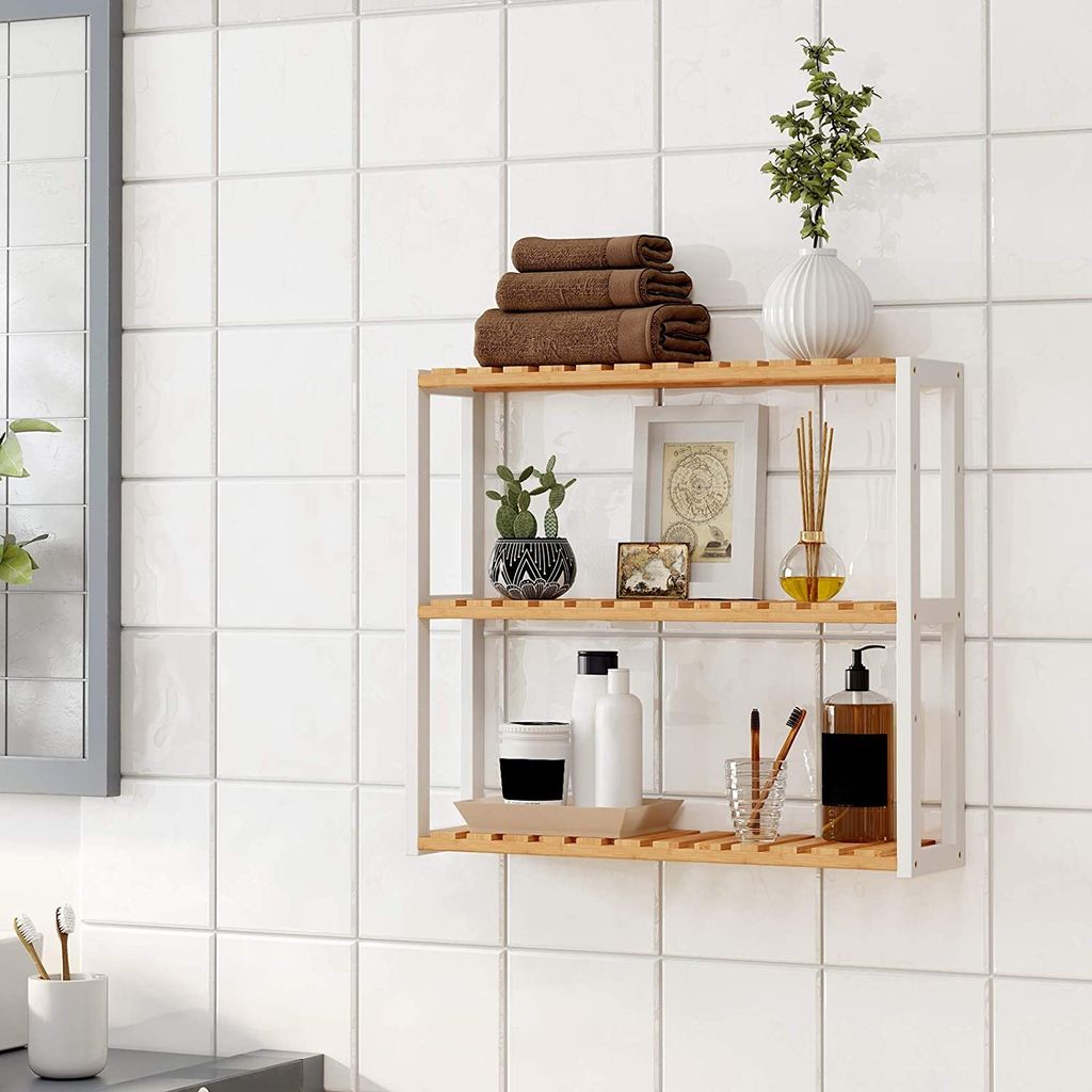 A wall-mounted shelving unit with bathroom accessories, placed against a tiled wall.