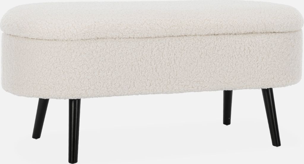A studio shot of an ecru bouclé storage bench with black legs.