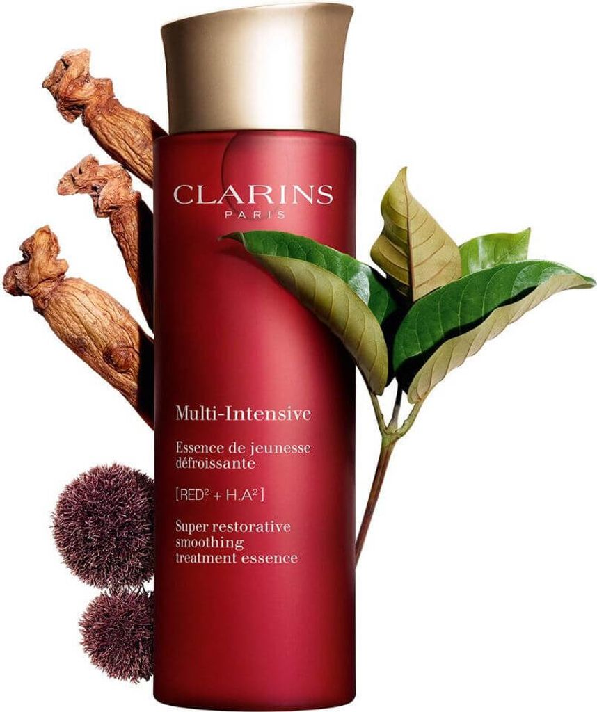 A red bottle of Clarins Super Restorative Smoothing Treatment Essence is displayed with natural elements like ginseng roots and leaves.