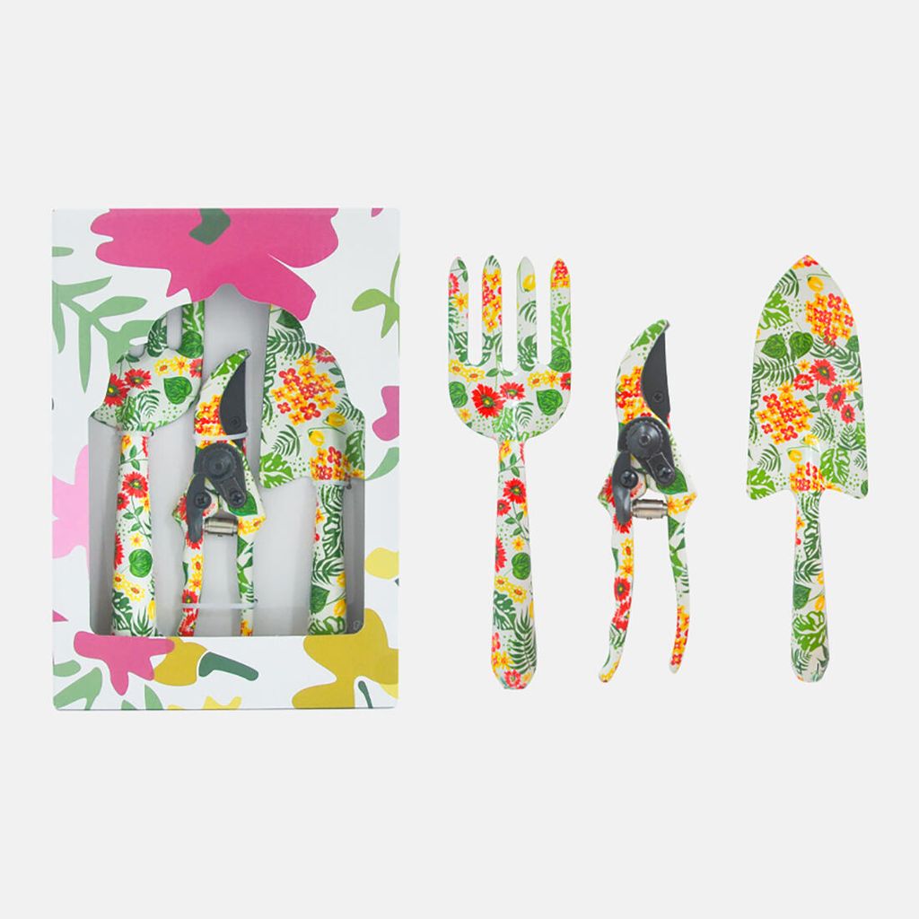 A set of three gardening tools with a floral pattern, displayed in a box and next to it.