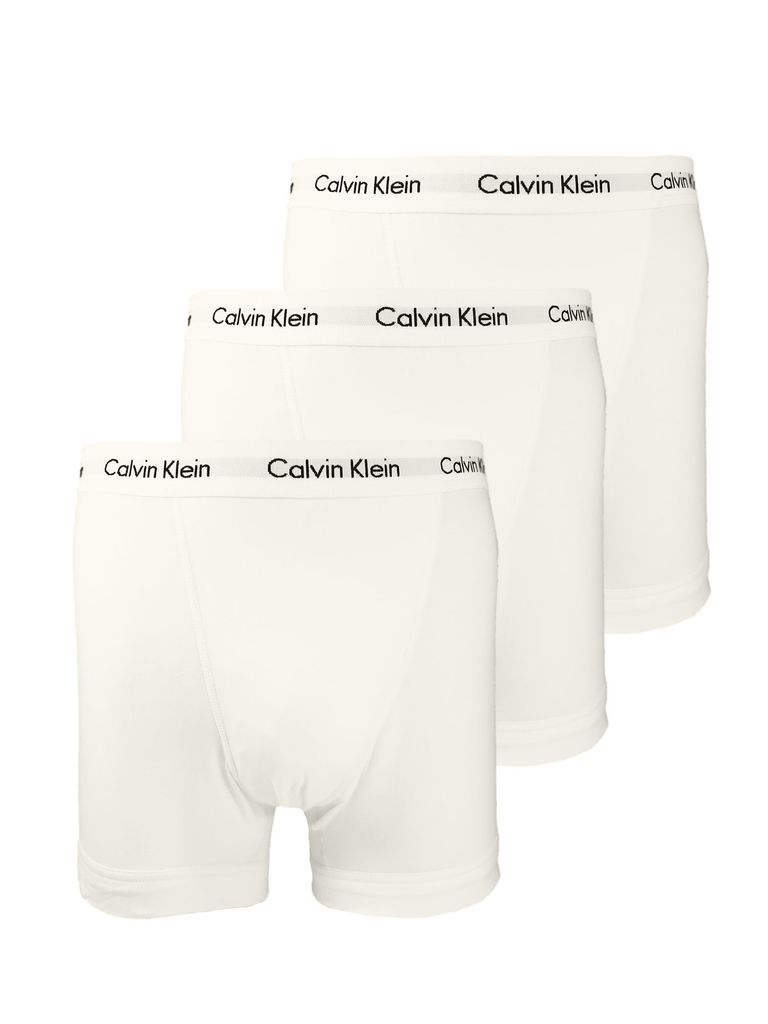 Three white Calvin Klein boxer briefs are arranged in a staggered formation against a white background.