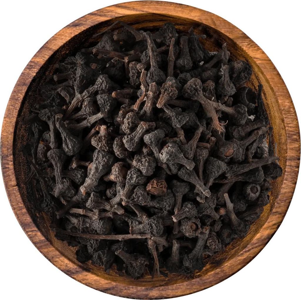 A close-up, top-down view of dried cinnamon buds in a wooden bowl.