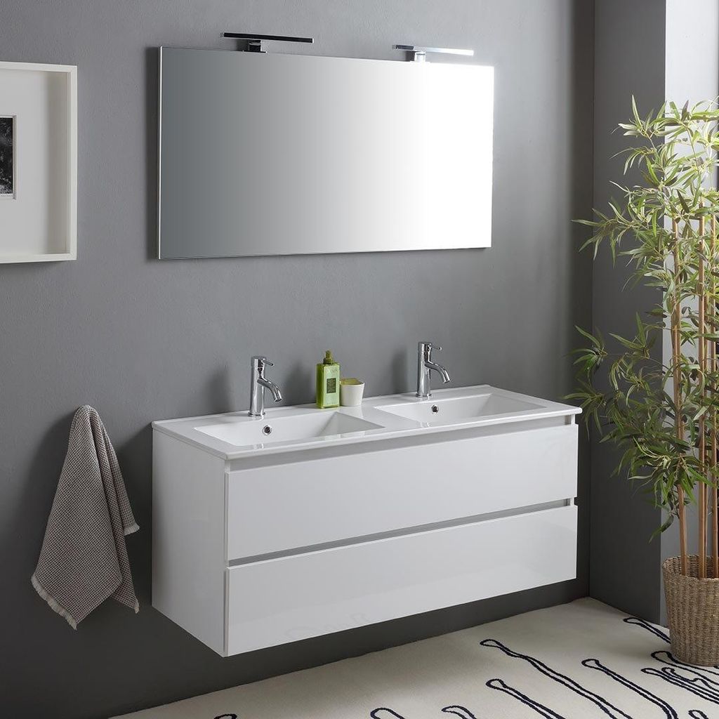 A modern bathroom vanity with a double sink, mirror, and a hanging towel.