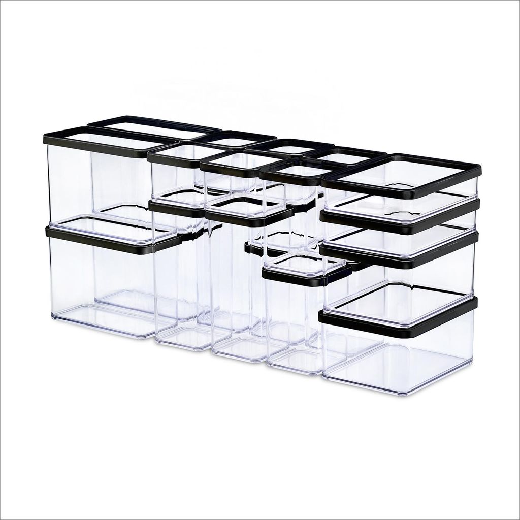 A collection of clear plastic food storage containers with black lids, arranged in rows.