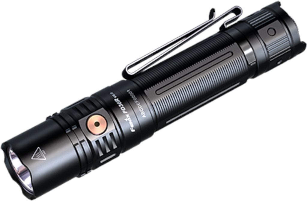 A studio shot of a black and gray flashlight with a copper button, set against a white background.