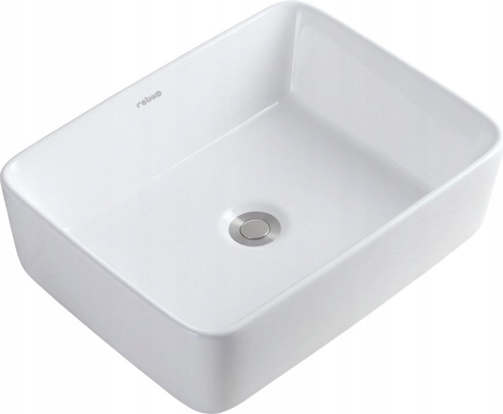 A white ceramic washbasin with a silver drain.