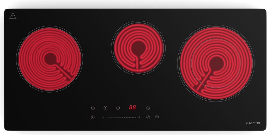 A top-down view of a black glass ceramic hob with three red heating elements.