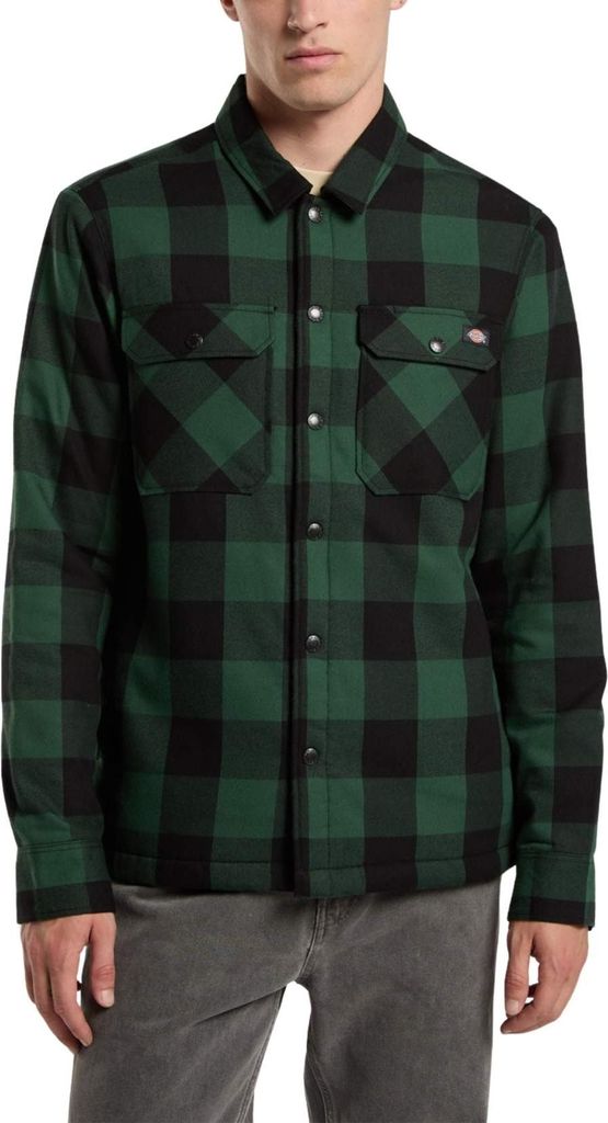 A man wearing a green and black plaid shirt.