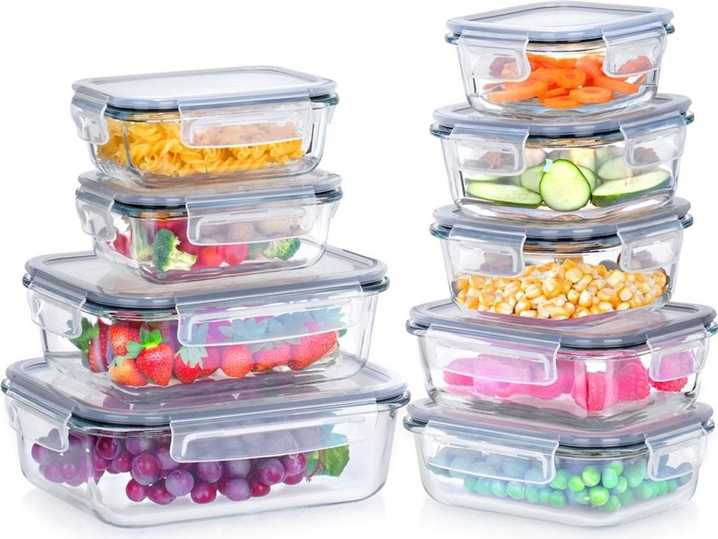 A set of glass food storage containers filled with various foods, stacked and arranged against a white background.