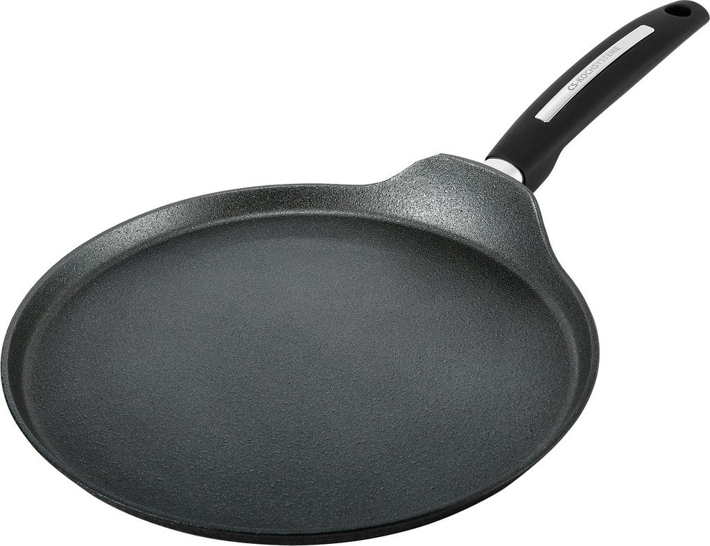 A black crepe pan with a silver and black handle is shown against a white background.