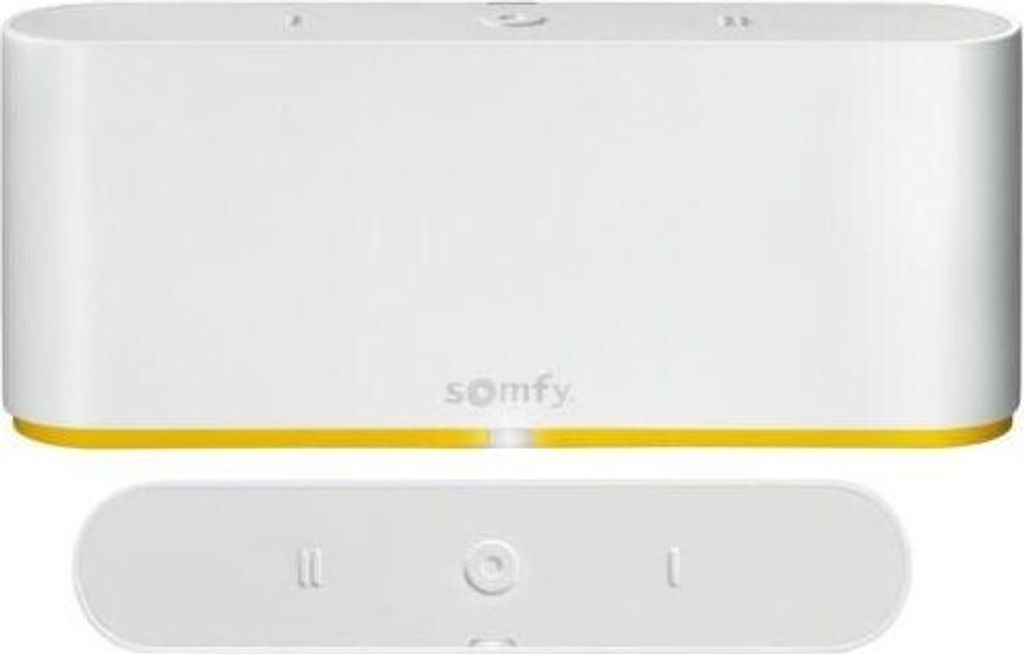 A white Somfy Tahoma Switch smart home hub and its remote control are shown against a white background.