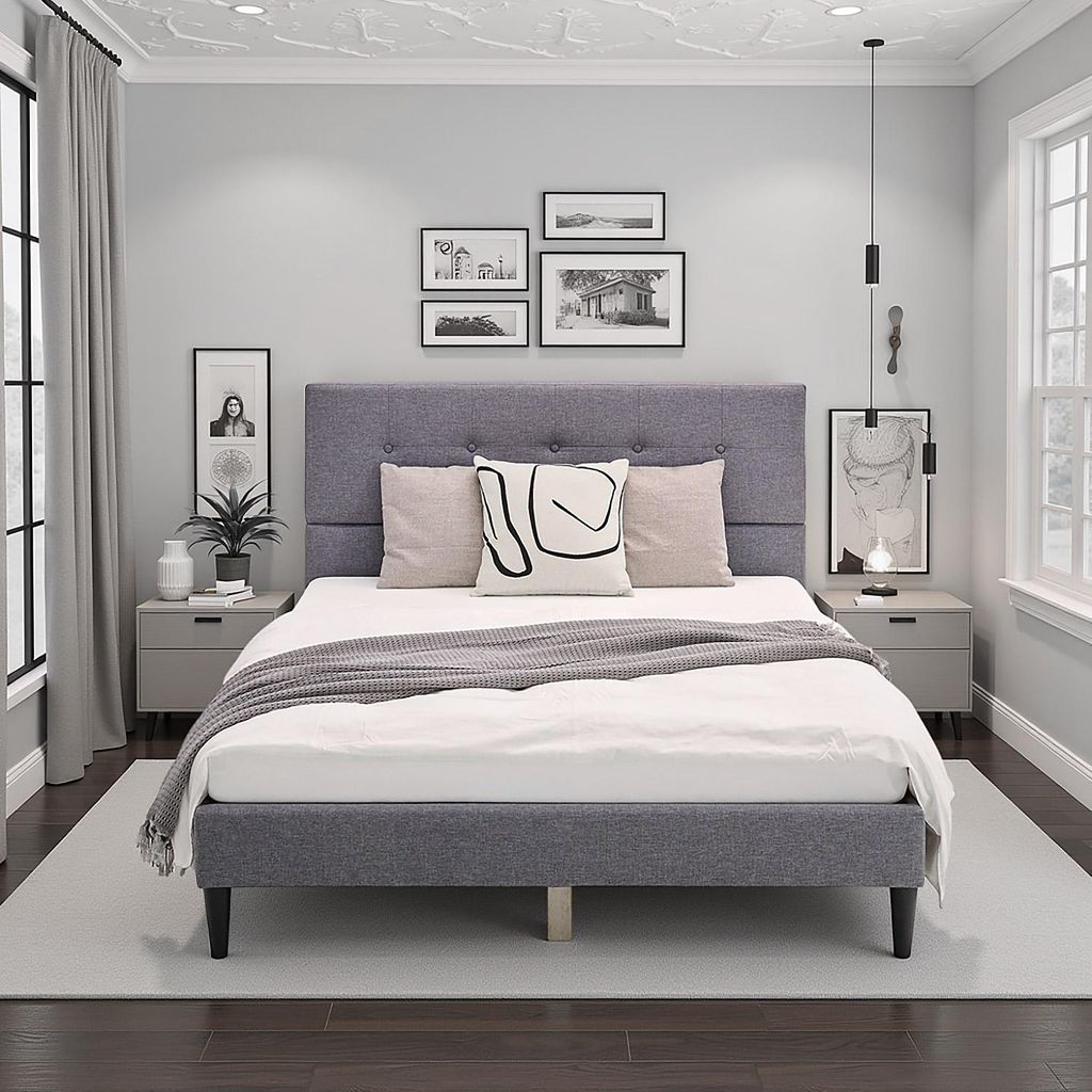 A bedroom scene featuring a gray upholstered bed.
