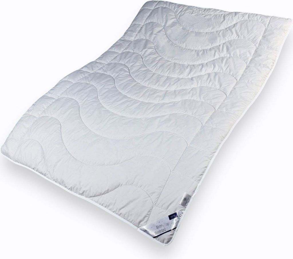 A white quilted blanket is shown lying diagonally on a white background.