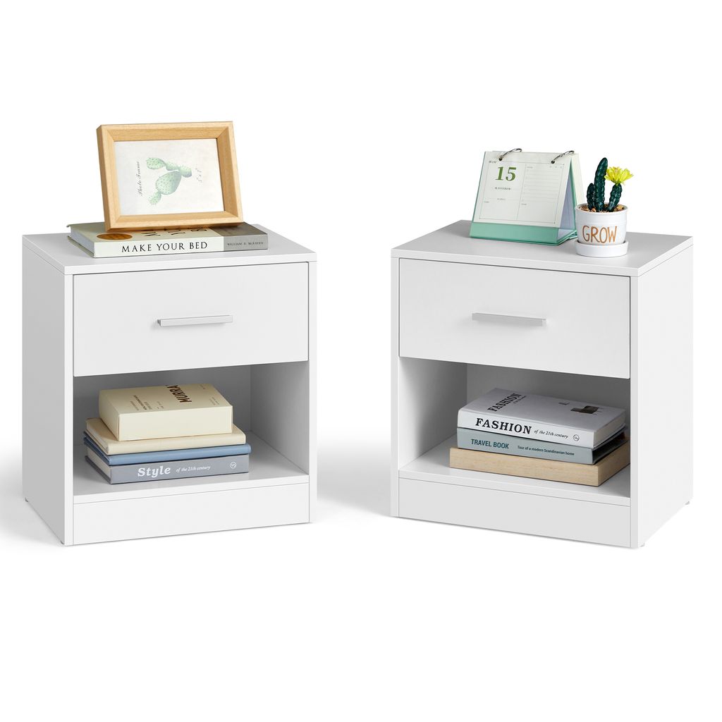 Two white nightstands are shown against a white background. The nightstands have drawers and open shelves. The left nightstand has a framed picture on top, and books inside the shelf. The right nightstand has a desk calendar and a small plant on top, and b