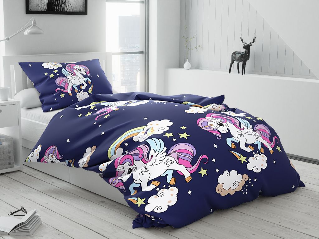 A bedroom scene with a bed made with unicorn-themed bedding.