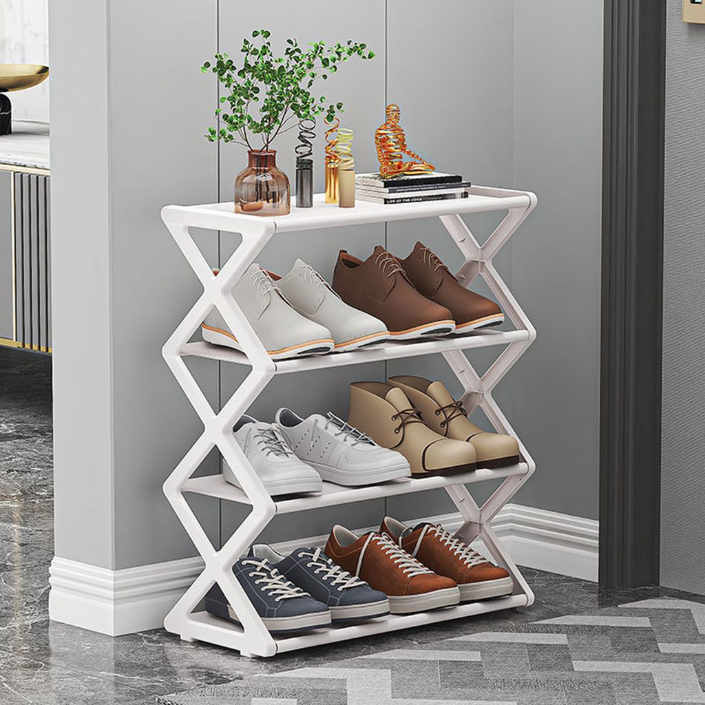 A white, foldable shoe rack with four shelves, neatly organized with various types of shoes on each level. Decorative items are placed on the top shelf.