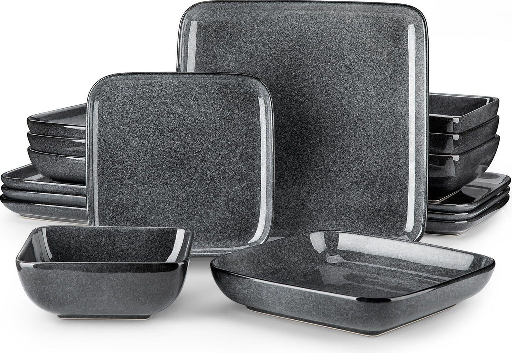A collection of dark gray stoneware dishes, including plates and bowls, arranged on a white background.
