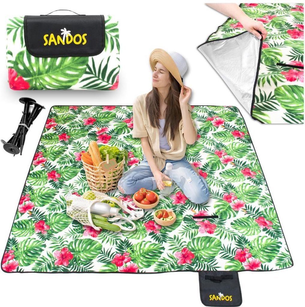 A woman is sitting on a picnic blanket with food and a basket.