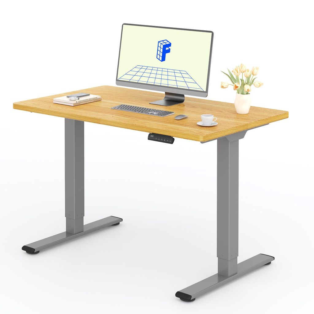 A standing desk with a computer, keyboard, mouse, and a vase of flowers.