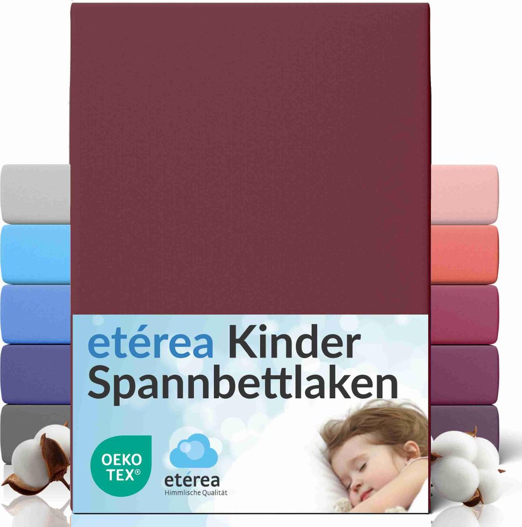 A product image showcasing a burgundy fitted sheet with multiple other colored fitted sheets stacked behind it, along with cotton bolls and a sleeping child.