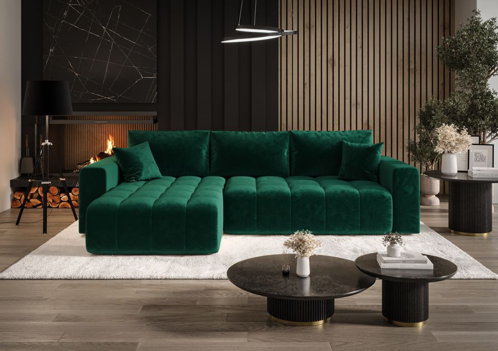 A luxurious living room with a large green sectional sofa, fireplace, and coffee tables.