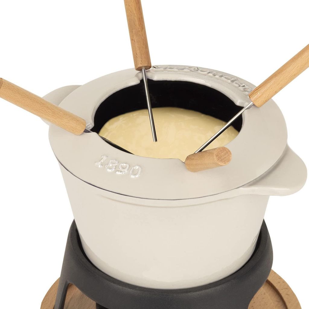 A close-up view of a fondue set with cheese inside.