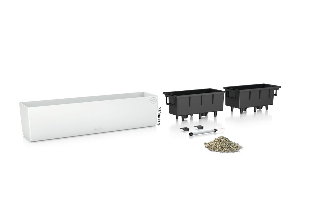 A white planter box and two black planting inserts are displayed on a white background, along with some small accessories and a pile of gravel.