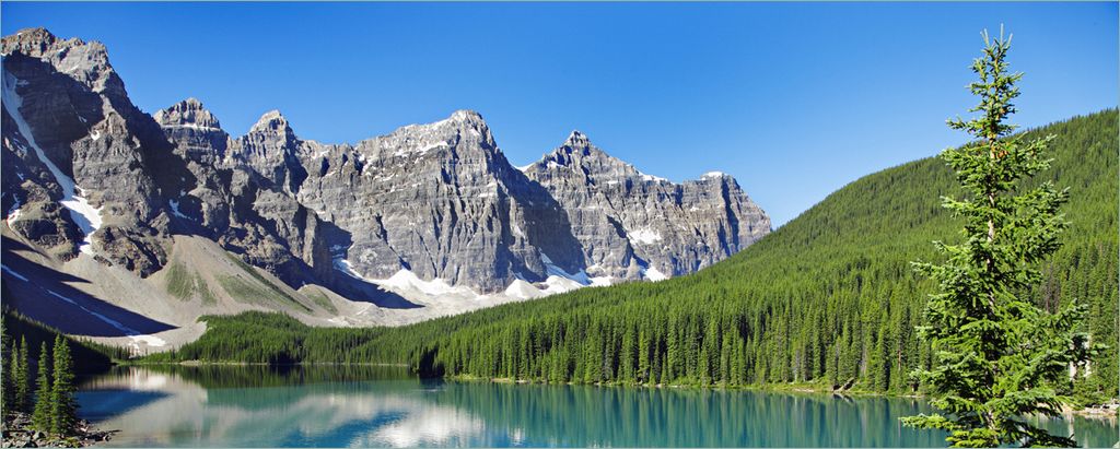 Wallario Poster - Tiefblauer See mit Bergpanorama und Wäldern Kanada, Kunstdruck Größe: 80 x 200 cm